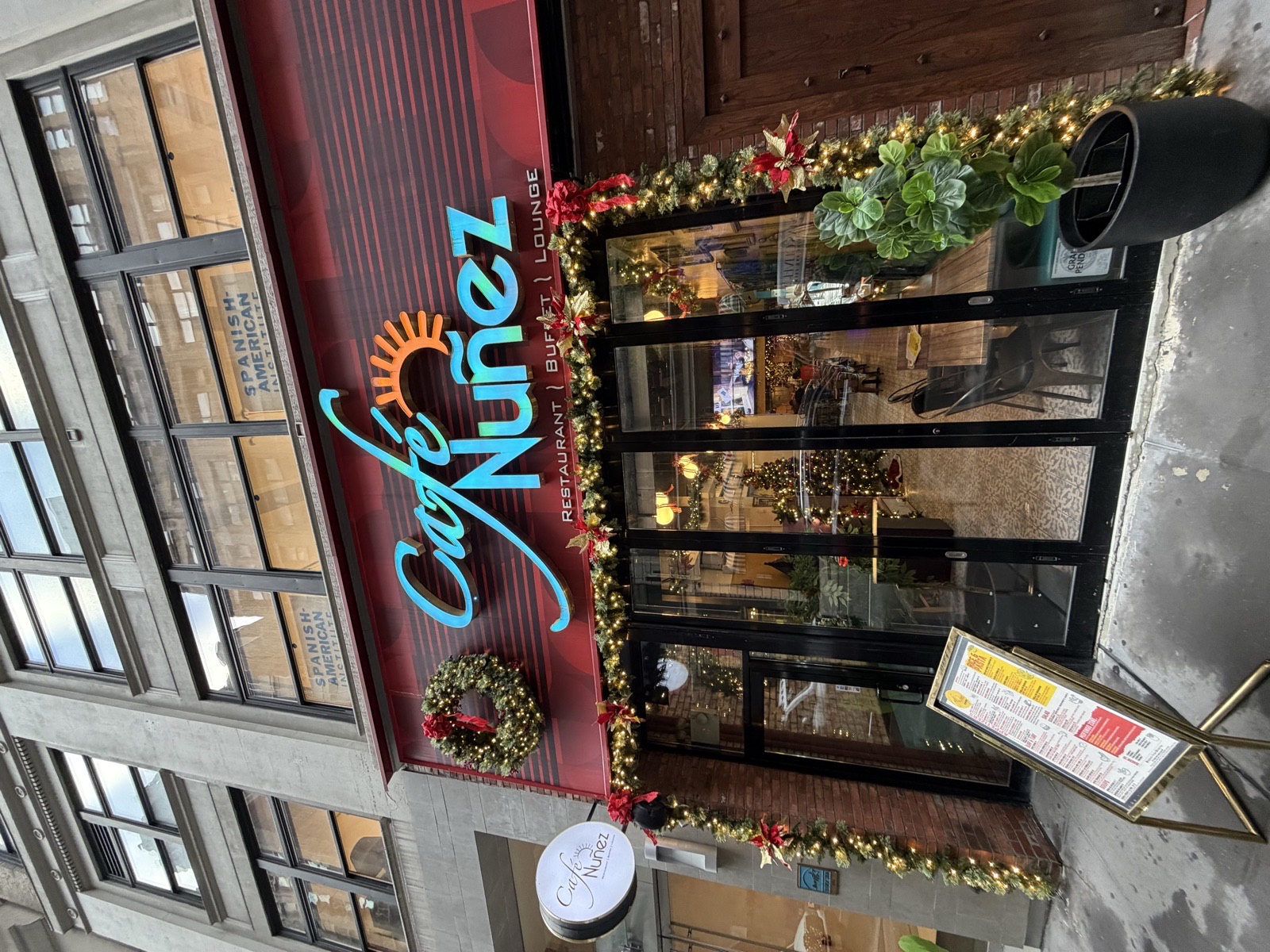 Café Nuñez storefront with garland and a wreath