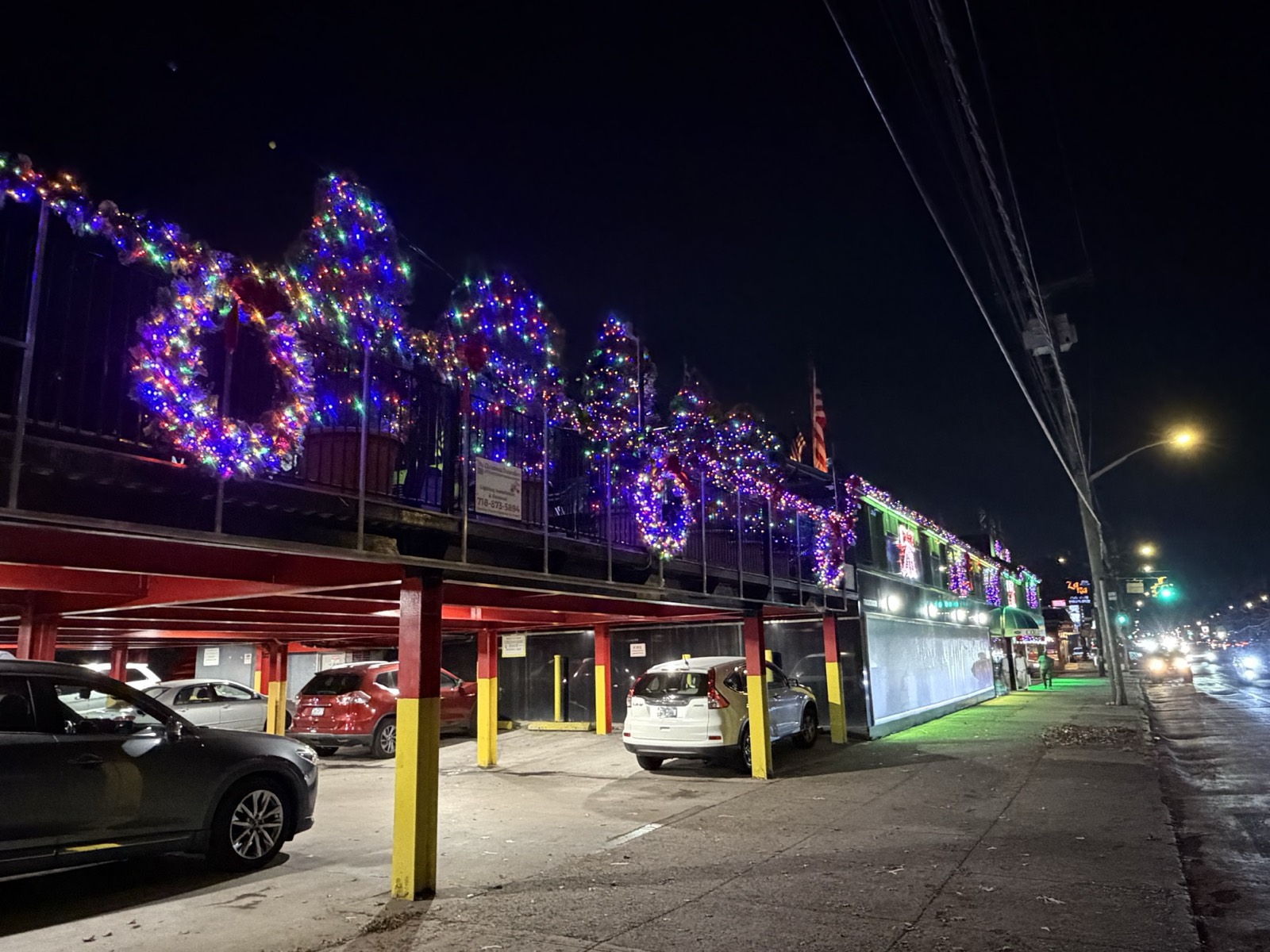Shopping plaza with lit wreaths along the roofline