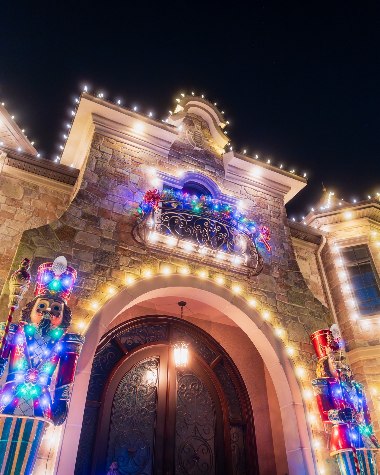 Arched front door flanked by giant nutcrackers