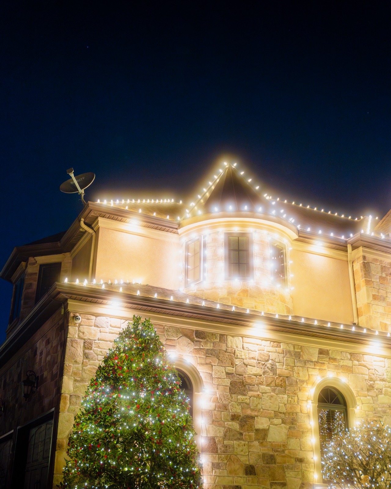 Château roofline outlined in warm-white bulbs